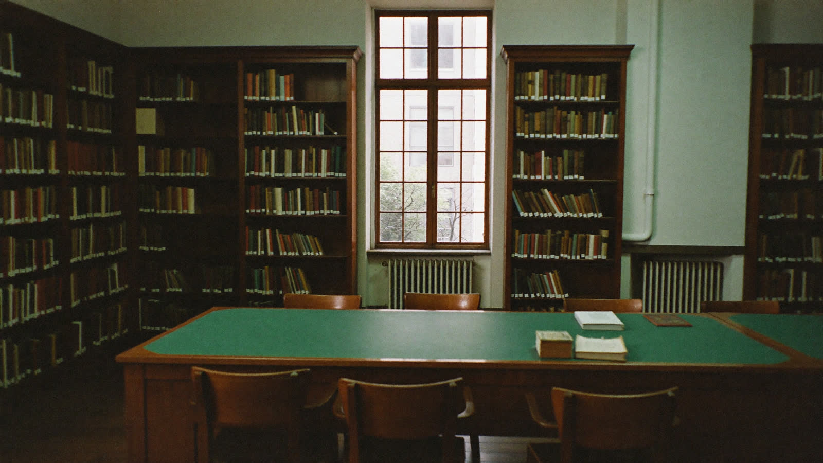 Warm university library with golden reading lamps