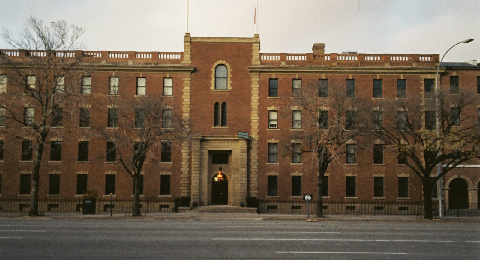 Grand stone facade of a historic New York City high school at golden hour